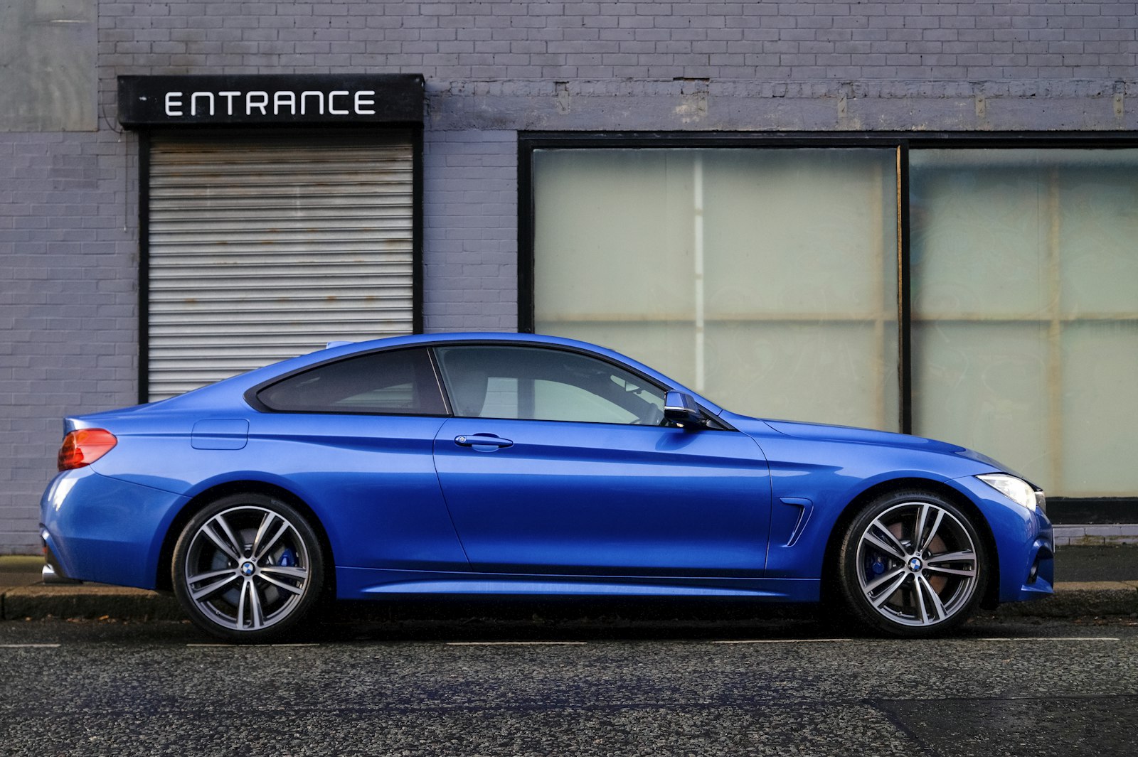 Blue sedan parked on a city street