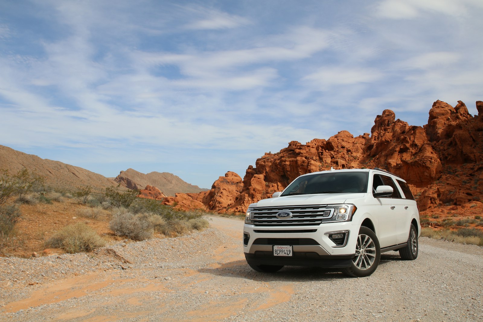White SUV on a scenic desert highway