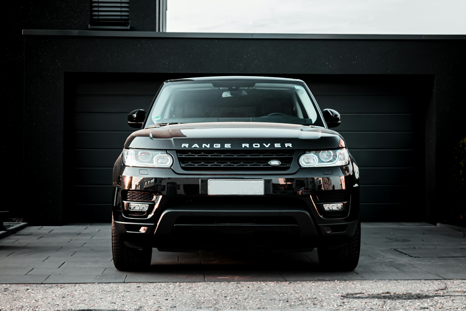 Black SUV ready outside a residence at night
