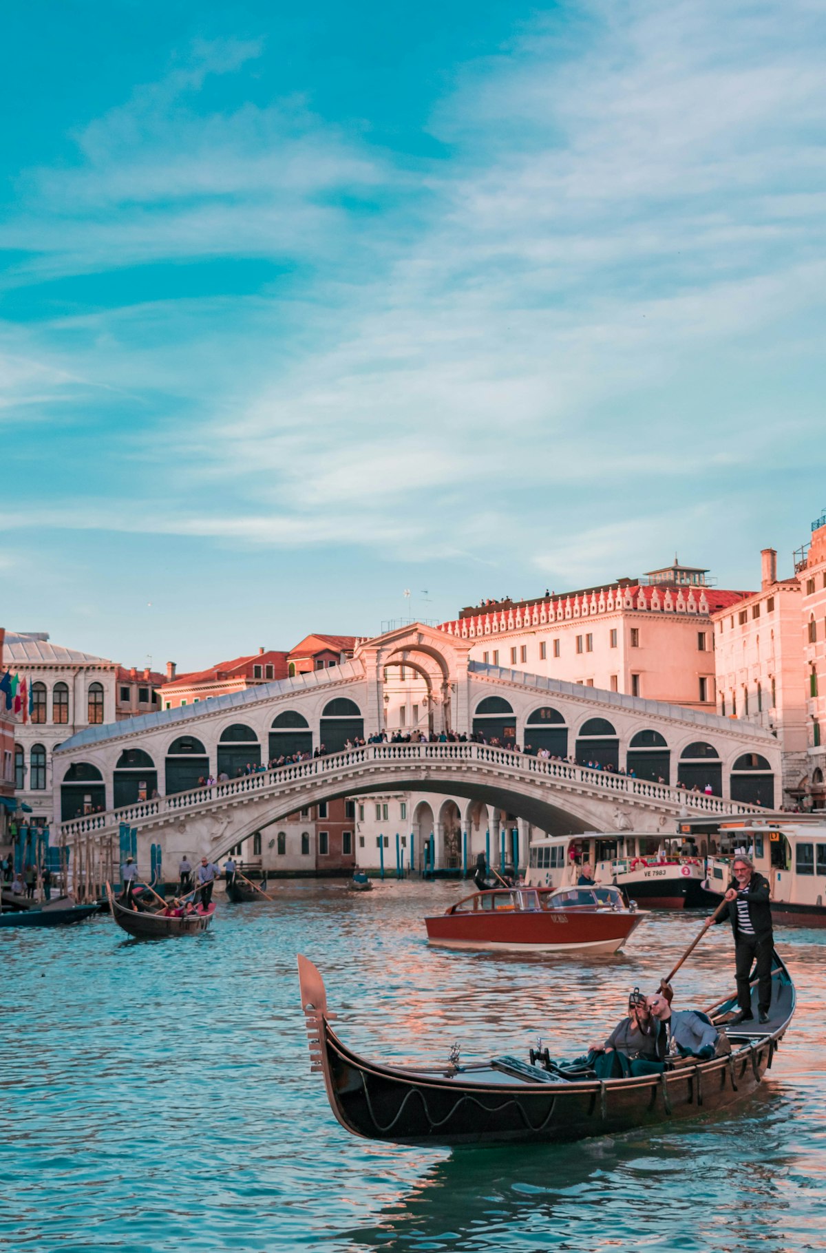 Gondola gliding under Venice's Rialto bridge